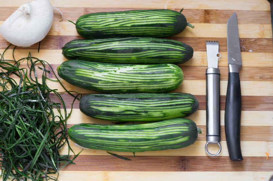 green delicious cucumbers on a wooden board