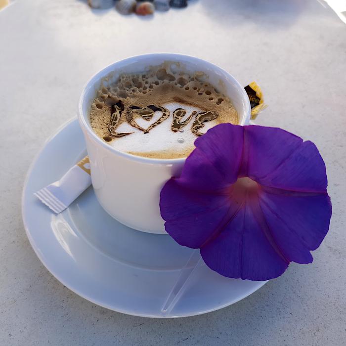 hot coffee decorated with a flower