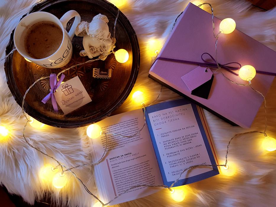decorated bed with lamps and a book