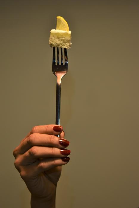 delicious dessert on a fork in the hand