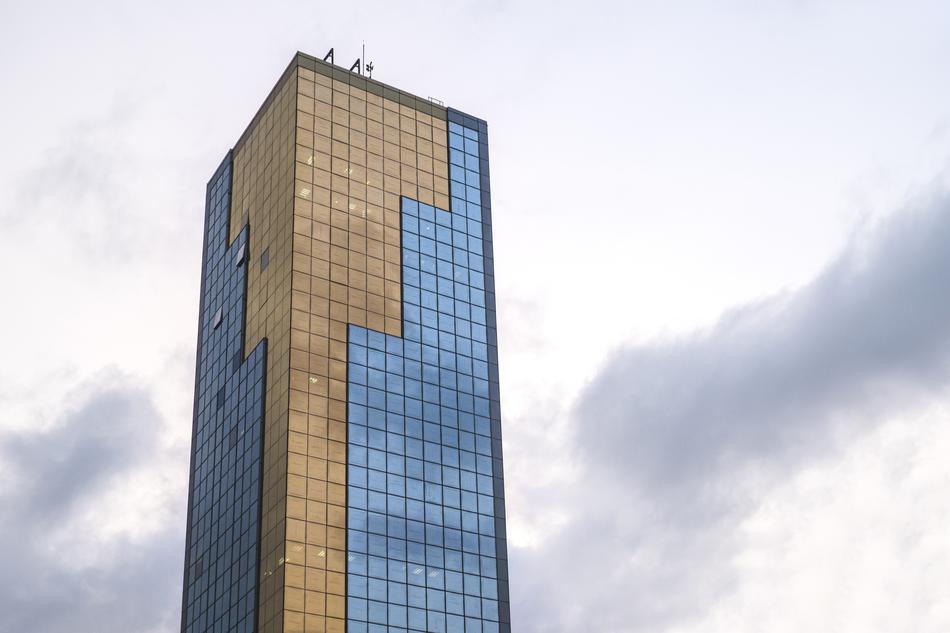 unusual glass building with clouds