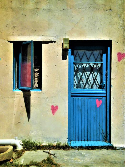 the blue door to the yellow building