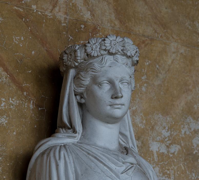 sculpture of a girl in a wreath