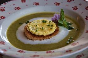 liquid soup with meat decorated with a flower