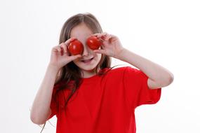 funny kid with tomatoes in his hands