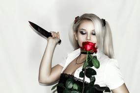 blonde with a red rose in her hand