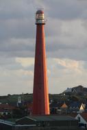 red lighthouse with houses