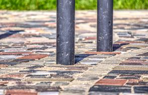 stone post on brick pavement