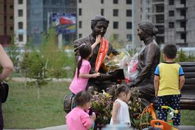 children play near the sculptures