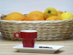 red mug on a background of fruit