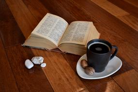 hot coffee with a book on the table