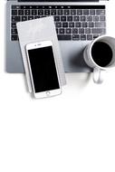 iphone on the computer and a mug of coffee