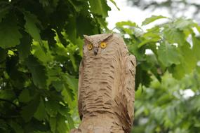 stone statue of an owl in the garden