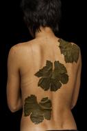 the leaves are green on the girl's back