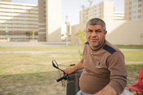 a man sitting near a soccer field