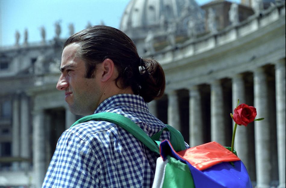 man with backpack and rose in Rome