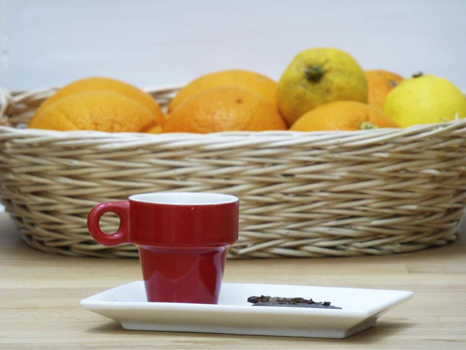 red mug on a background of fruit