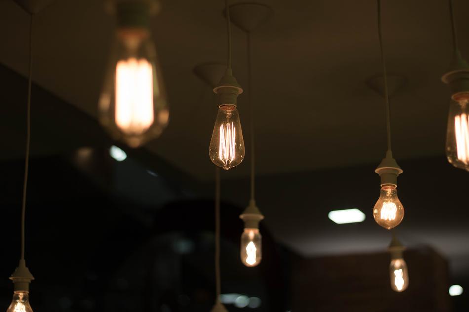 Close-up of the glass lamps on the ceiling, among the darkness
