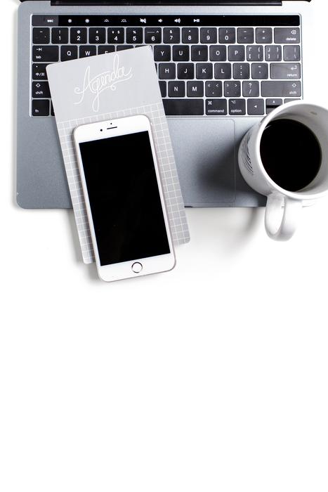 iphone on the computer and a mug of coffee