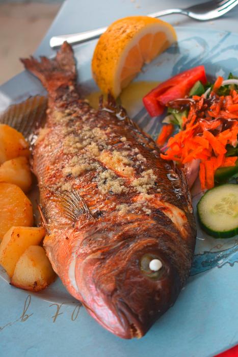 red fish with spices and vegetables