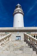 a big lighthouse in the blue sky