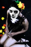 a girl with flowers in her head and a white face