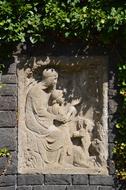 stone silhouette on a green background of bushes