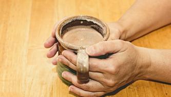 hot coffee in a ceramic mug in hand