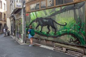 a man near graffiti on the street