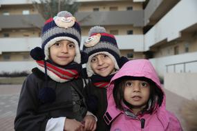 three kids in a group photo