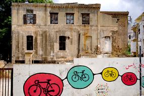 graffiti of bicycles on the wall by the ruins