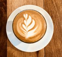 hot foam coffee with leaf pattern