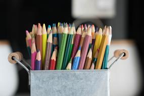 lot of Coloured Pencils in metal container