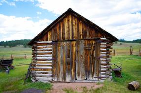 wooden house with a green meadow