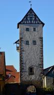 a large stone tower with a blue background