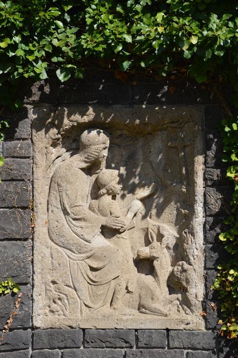 stone silhouette on a green background of bushes