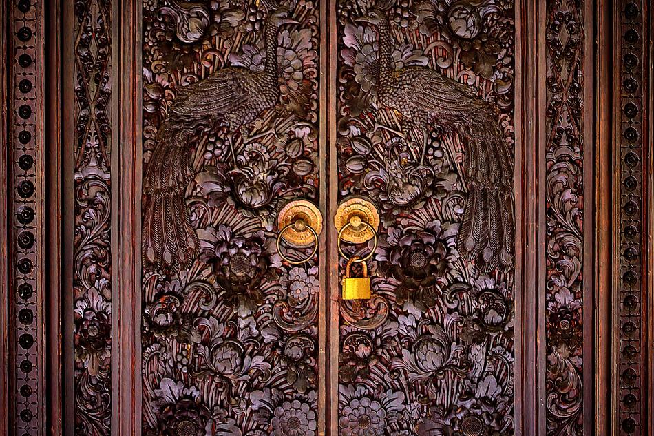 brown patterned doors with gold handles.