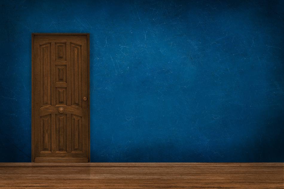 the wooden door to the blue building