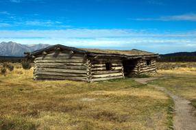 wooden house with a field