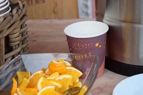 sliced orange near the coffee cup