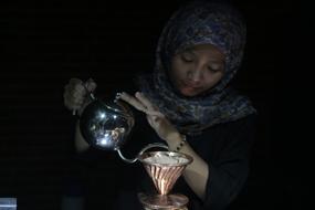 girl in scarf with a kettle for coffee