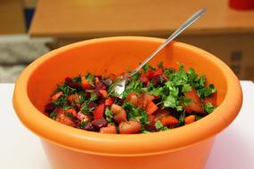 healthy sliced salad in an orange plate