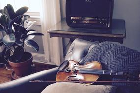 Violin on armchair in vintage interior