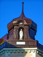 a wooden church with a sculpture of a white