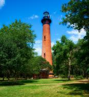 red lighthouse green trees