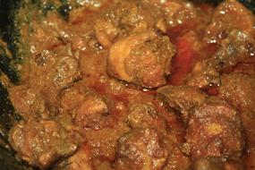roasted tasty meat in sauce in a skillet