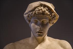 stone head sculpture of hermes