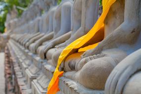 the orange scarf on the sculptures