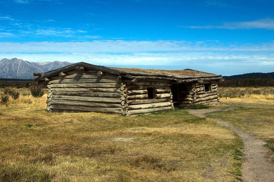 wooden house with a field