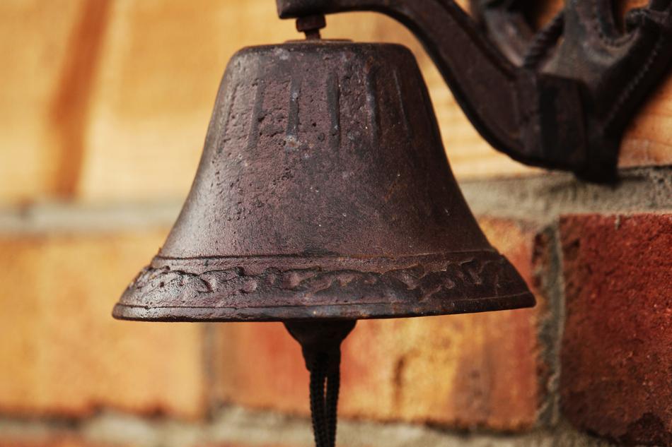 Beautiful garden bell on the brick wall